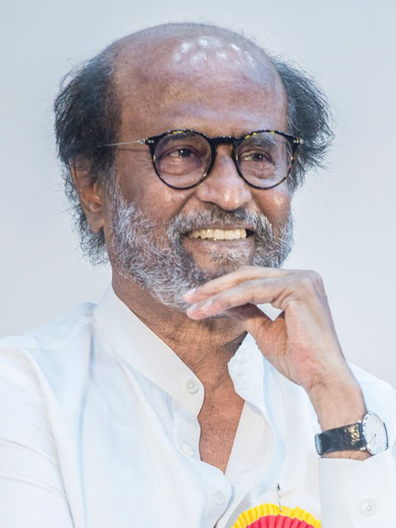 Rajinikanth smiling, wearing glasses and a white shirt